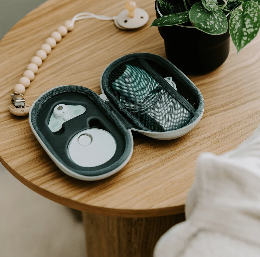 Sleep On The Go travel case with Dream Sock and base, open on a nightstand